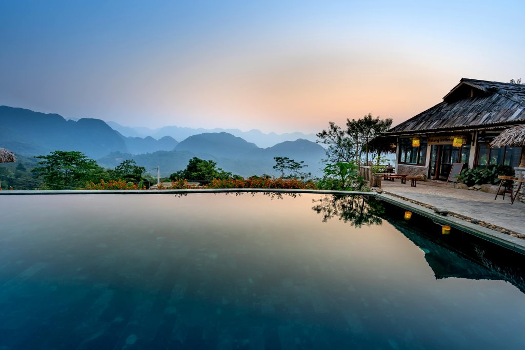 Serene villa with infinity pool and mountain backdrop, perfect for relaxation.